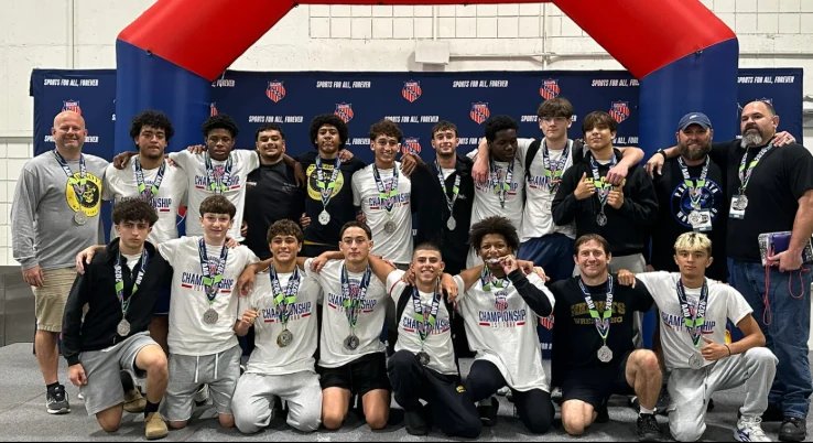 Boys wrestlers and coaches at the 2026 AAU Scholastic Duals